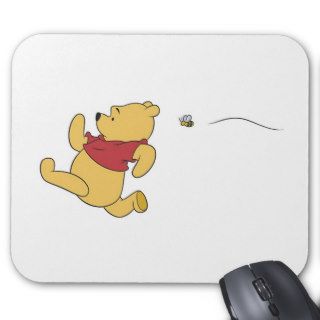 Winnie The Pooh chased by bee Mousepads