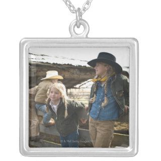 Young cowboys and cowgirls hanging out at corral necklaces