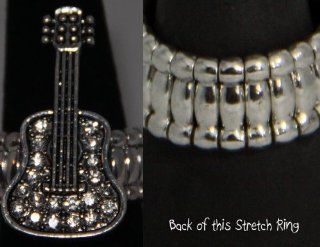 From the Heart Beautiful Guitar "Stretch" Ring with Clear Crystal Rhinestones which Sparkle Approximately 1 1/2 inch long & 1 inch wide. Rear appears to be solid Silver Toned Metal . One Size Fits Most. Mailed in a Gift Box  Celebrate Music w