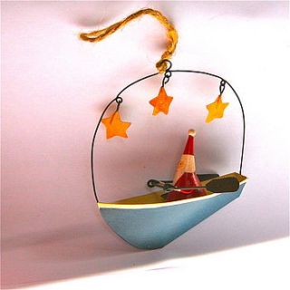 santa in blue boat with stars decoration by london garden trading