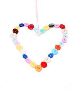 hanging button heart by the blue pebble