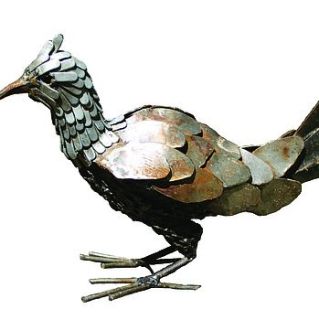 metal chicken by garden beet