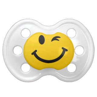 Winking smiley face pacifiers