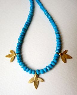 gold plate ami leaves on turquoise necklace by blossoming branch