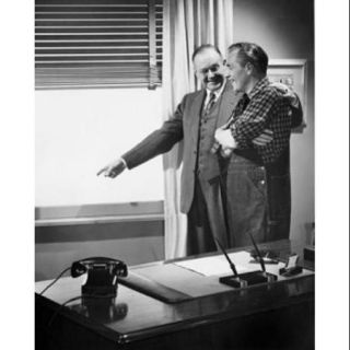 Businessman and farmer looking through window Poster Print (18 x 24)